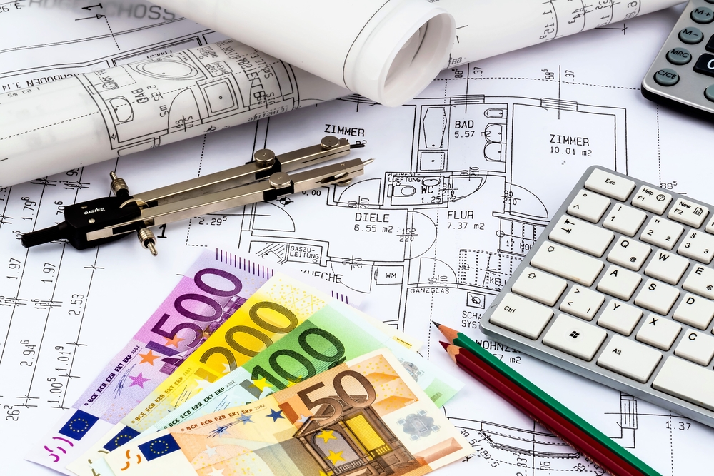 blueprint of an architect with money symbolic photo for financing